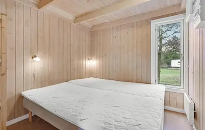 a bed in a room with a window at Stunning Home In Hanstholm With Wifi in Hanstholm