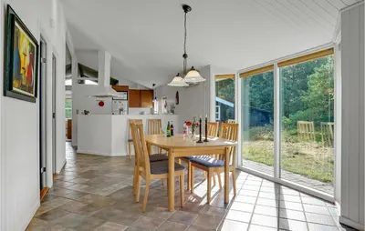 a kitchen and dining room with a table and chairs at Stunning Home In Fjerritslev With Sauna in Fjerritslev