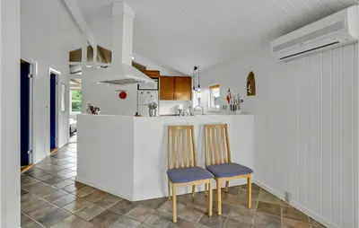 a kitchen with two chairs and a counter at Stunning Home In Fjerritslev With Sauna in Fjerritslev