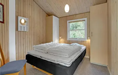 a bedroom with a bed in a room with a window at Stunning Home In Fjerritslev With Sauna in Fjerritslev