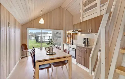 a kitchen and dining room with a table and chairs at Stunning Home In Hanstholm With Wifi in Hanstholm