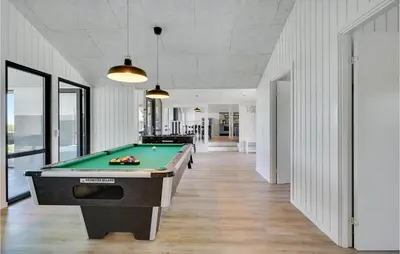 a pool table in a room with white walls at Nice Home In Blokhus With Wifi in Blokhus
