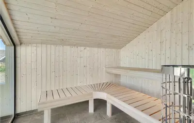a sauna with a wooden bench in a room at Nice Home In Blokhus With Wifi in Blokhus