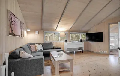 a living room with a couch and a table at 3 Bedroom Cozy Home In Højslev in Højslev