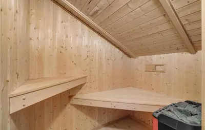 a wooden sauna with a wooden shelf in it at 3 Bedroom Cozy Home In Højslev in Højslev