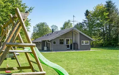 a playground with a house and a slide at 3 Bedroom Cozy Home In Højslev in Højslev