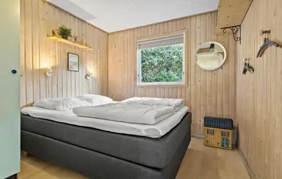 a bedroom with a bed in a room with a window at 2 Bedroom Awesome Home In Farsø in Farsø