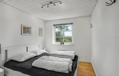 a bedroom with two beds and a window at Pet Friendly Home In Farsø With Sauna in Farsø