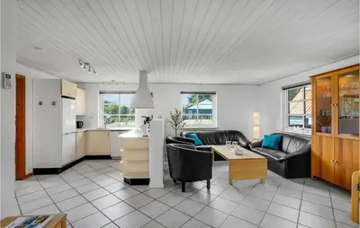 a living room with a couch and a table at Pet Friendly Home In Farsø With Sauna in Farsø