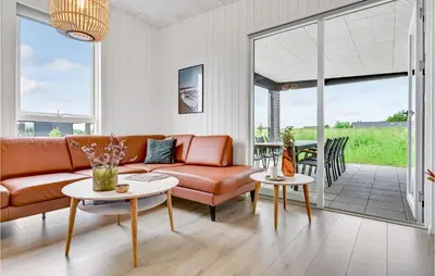 a living room with a couch and tables at 4 Bedroom Awesome Home In Løgstrup in Løgstrup