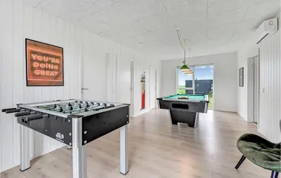 a room with a foosball table and a pool table at 4 Bedroom Awesome Home In Løgstrup in Løgstrup