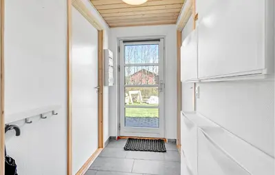 a hallway with a door leading into a kitchen at 3 Bedroom Beautiful Home In Farsø in Farsø