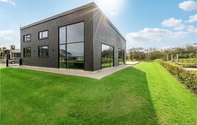 a house with a large lawn in front of it at Lovely Home In Løgstrup With Wifi in Løgstrup