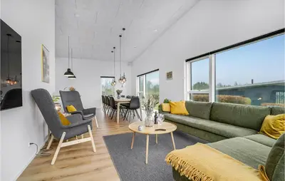 a living room with a couch and a table at Lovely Home In Løgstrup With Wifi in Løgstrup