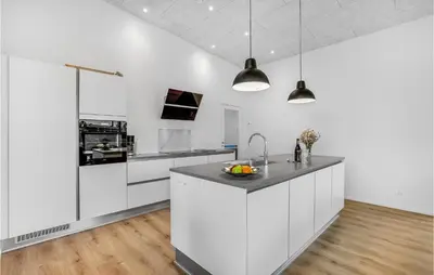 a kitchen with white cabinets and a sink at Lovely Home In Løgstrup With Wifi in Løgstrup
