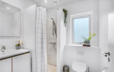 a white bathroom with a shower and a toilet at Lovely Home In Løgstrup With Wifi in Løgstrup