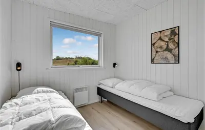 a white bedroom with a bed and a window at Beautiful Home In Løgstrup With Kitchen in Løgstrup