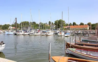 a bunch of boats are docked in a harbor at Beautiful Home In Løgstrup With Kitchen in Løgstrup