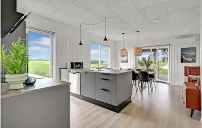 a kitchen and living room with a island and chairs at Beautiful Home In Løgstrup With Kitchen in Løgstrup
