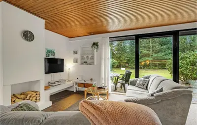 a living room with a couch and a tv at Lovely Home In Højslev With Wifi in Højslev