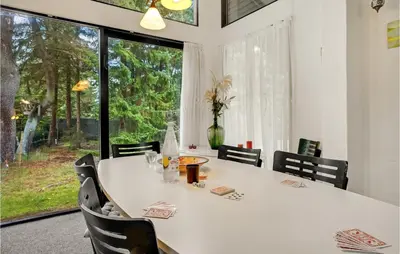 a dining room with a white table and a large window at Lovely Home In Højslev With Wifi in Højslev