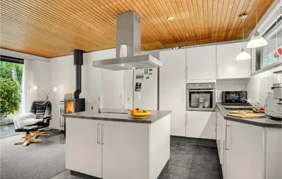 a kitchen with white cabinets and a wooden ceiling at Lovely Home In Højslev With Wifi in Højslev