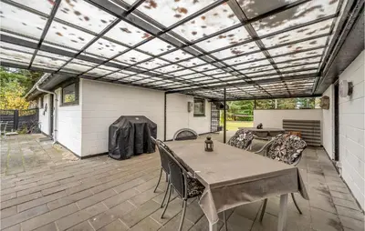 a patio with a table and chairs on a deck at Lovely Home In Højslev With Wifi in Højslev