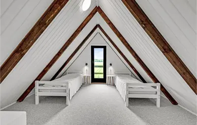 a room with two beds in a attic at Beautiful Home In Løgstrup With Wifi in Løgstrup