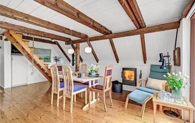a dining room with a table and chairs and a fireplace at Beautiful Home In Løgstrup With Wifi in Løgstrup