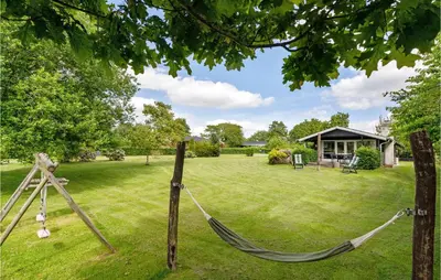a hammock in the middle of a yard at Gorgeous Home In Farsø With Kitchen in Farsø