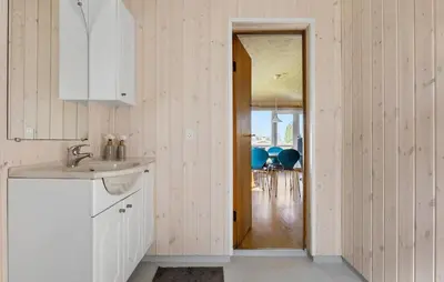 a kitchen with a sink and a door to a dining room at Gorgeous Home In Farsø With Kitchen in Farsø
