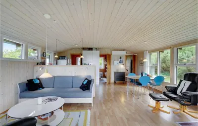 a living room with a blue couch and chairs at Gorgeous Home In Farsø With Kitchen in Farsø