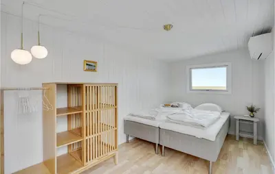 a white bedroom with a bed and a window at 1 Bedroom Beautiful Home In Løgstør in Løgstør