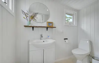 a white bathroom with a sink and a toilet at 1 Bedroom Beautiful Home In Løgstør in Løgstør