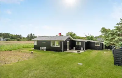 a black tiny house in a yard at 1 Bedroom Beautiful Home In Løgstør in Løgstør