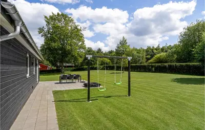 a yard with a swing set in the grass at Amazing Home In Farsø With Wifi in Farsø
