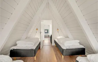 two beds in a room with a attic at 2 Bedroom Cozy Home In Farsø in Farsø