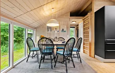 a dining room with a table and chairs at 3 Bedroom Cozy Home In Nibe in Nibe