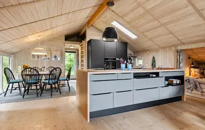 a kitchen and dining room with a table and chairs at 3 Bedroom Cozy Home In Nibe in Nibe
