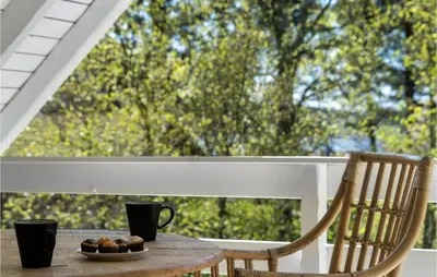 a table with a plate of food on a porch at 3 Bedroom Cozy Home In Højslev in Højslev
