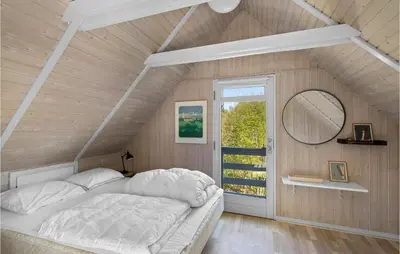 a bedroom with a bed and a mirror and a window at 3 Bedroom Cozy Home In Højslev in Højslev