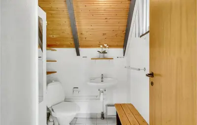 a bathroom with a white toilet and a sink at Nice Home In Løgstrup With Wifi in Løgstrup