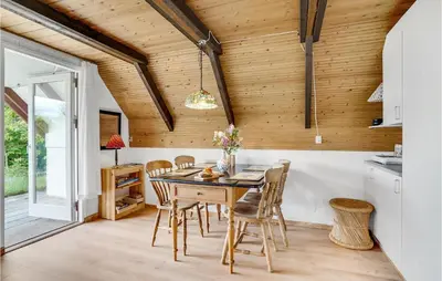 a kitchen with a wooden ceiling and a table and chairs at Nice Home In Løgstrup With Wifi in Løgstrup