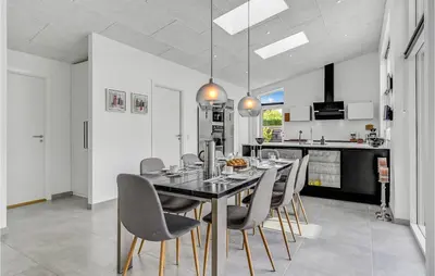 a kitchen and dining room with a table and chairs at Cozy Home In Farsø With Wifi in Farsø