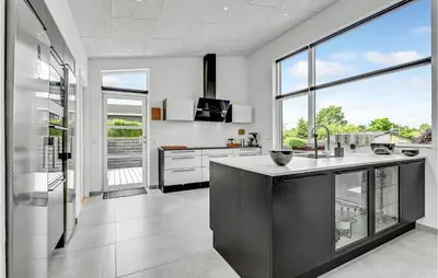 a kitchen with white appliances and large windows at Cozy Home In Farsø With Wifi in Farsø