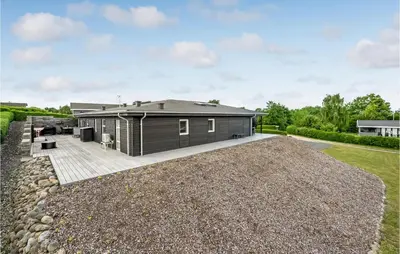a modular home with a large yard at Cozy Home In Farsø With Wifi in Farsø