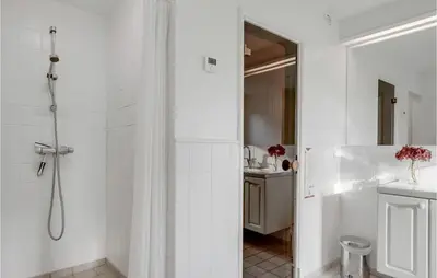 a white bathroom with a shower and a sink at Amazing Home In Blokhus With Wifi in Blokhus