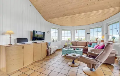 a living room with a couch and a tv at Awesome Home In Lemvig With Kitchen in Lemvig