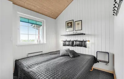a bedroom with a bed and a window at Awesome Home In Lemvig With Kitchen in Lemvig