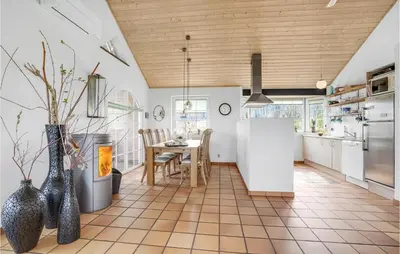 a kitchen with a table and a refrigerator at Awesome Home In Lemvig With Kitchen in Lemvig